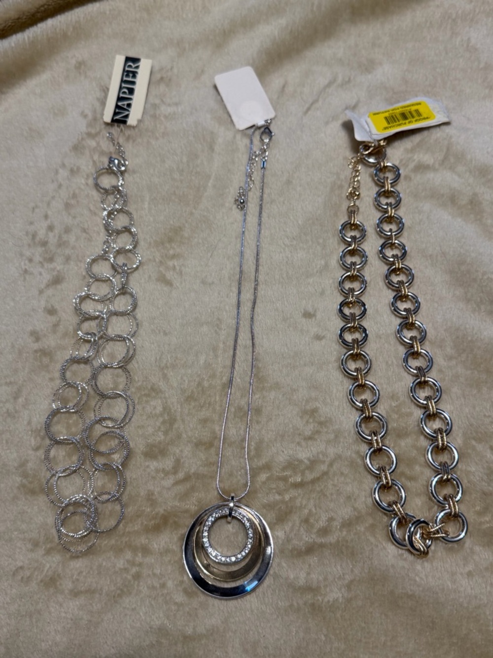 Three necklaces; one silver and two with silver and gold.